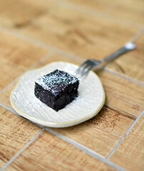 Brownies with fork in dish on table with shallow depth of field