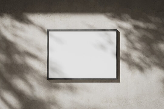 Landscape blank white A0 poster in a metal frame on a plaster wall