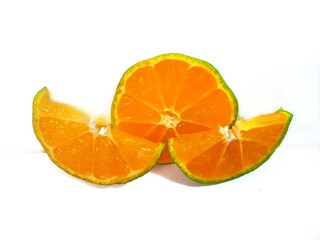 half lemon and slice isolated on white background. orange peel is green.