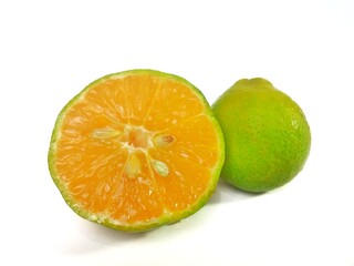 Lemon and slice isolated on white background. orange peel is green
