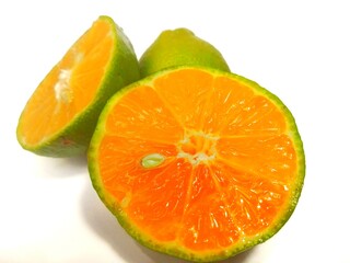 Lemon and slice isolated on white background. orange peel is green