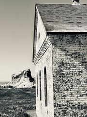 A black and white capture of a former foghorn station's architectural details, with its distinctive...