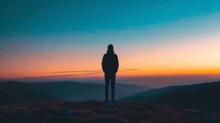 Fototapeta premium Mystical silhouette of a lone figure standing on a hillside