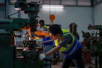 Blue collar workers upskill at lathe machine shop.