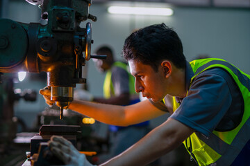 Blue collar workers upskill at lathe machine shop.