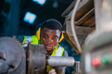 Blue collar worker upskills at lathe machine shop.