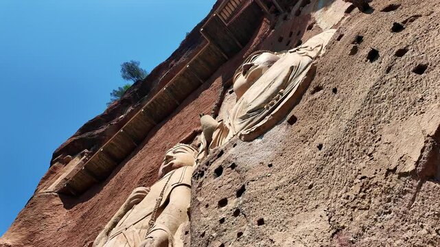 Tianshui, China: Pan footage of the famous Maijishan grottoes and itsmassive Buddha statues in Gansu province in China. It was an important stop on the silk road. 