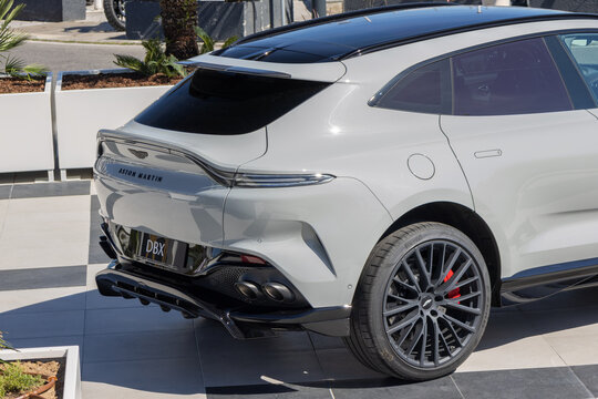 Aston martin dbx suv standing on a showroom tiled floor