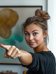 Fototapeta premium photo of a woman pointing at the camera and asking not to be photographed