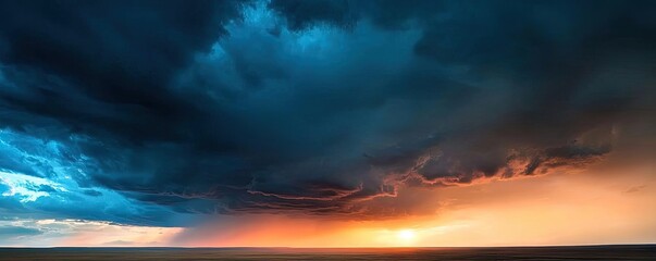 Fototapeta premium Dramatic sunset over ocean with dark clouds creating a stunning sky.