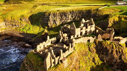 Dunluce Castle in Northern Ireland aerial view - Ancient Ruins Majestically Overlooking the...