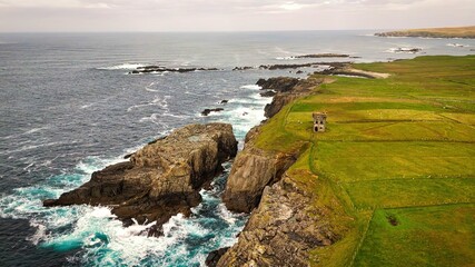 Malin Beg at the west coast of Ireland in Donegal - breathtaking coastal landscape that beautifully overlooks a rocky shoreline and the vast ocean