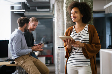 Portrait of happy success black woman working in a busy modern workplace, Startup coworker concept