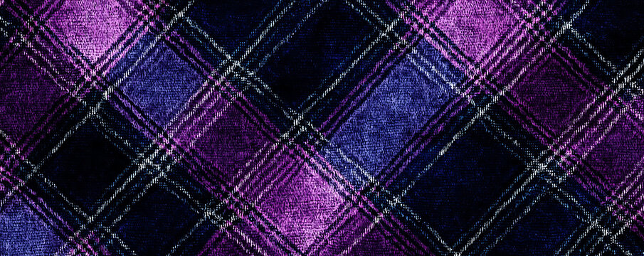 A close-up view of a fuzzy tartan fabric with a checkered pattern in shades of purple, navy, and black.