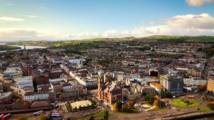 Obraz premium City of Derry aka Londonderry in Northern Ireland aerial view - A Dramatic Cityscape by the River Foyle Featuring a Beautiful Pedestrian Bridge