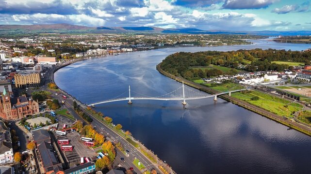 City of Derry aka Londonderry in Northern Ireland aerial view - A Dramatic Cityscape by the River Foyle Featuring a Beautiful Pedestrian Bridge