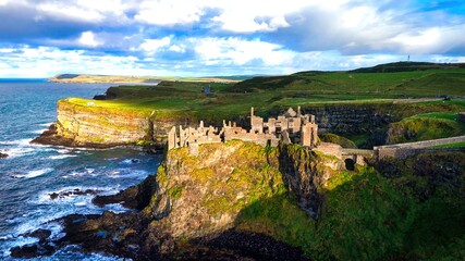 Dunluce Castle in Northern Ireland aerial view - Ancient Ruins Majestically Overlooking the...