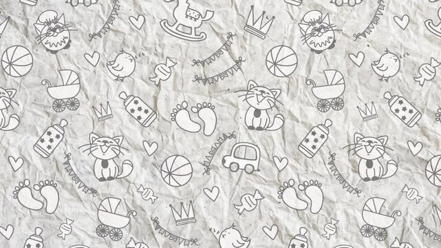 Videophone on crumpled paper with children's toys. Ball, stroller, bottle, footprints, bird, cats