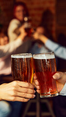 Cheers to game. Friends gather, drinks in hand, while background buzzes with energy. Bar atmosphere...