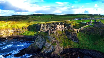 Dunluce Castle in Northern Ireland aerial view - Ancient Ruins Majestically Overlooking the Glorious Sea in a Stunning and Breathtaking Landscape