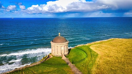 Mussenden Temple at the west coast of Northern Ireland in an enchanting Coastal Landscape featuring...