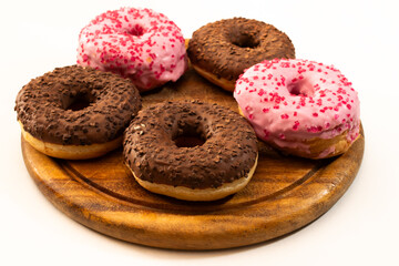 five donuts on a wooden plate