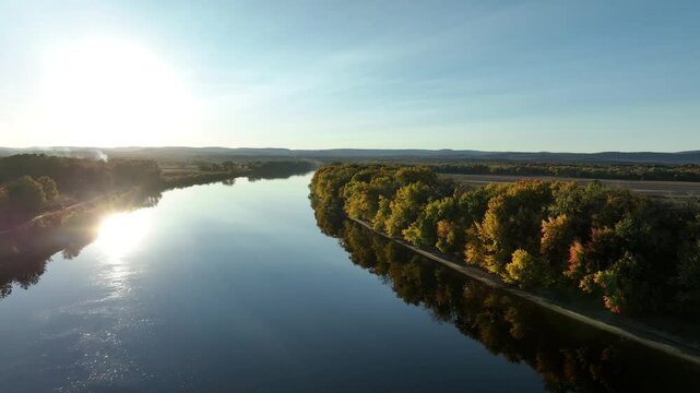Drone shot capturing Connecticut River during sunset in Hadley Massachusetts, USA. Autumn fall.