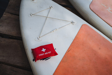 A wellorganized first aid kit is placed securely on top of a surfboard, prepared for any...