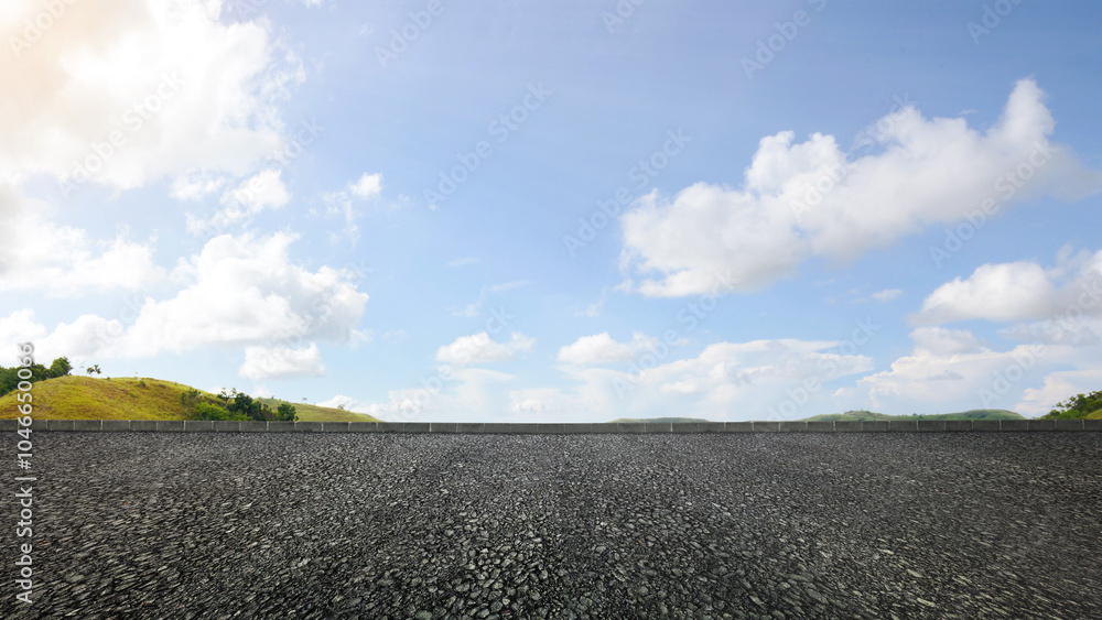 Poster asphalt street and mountain range view with blue sky and clouds in the background. the sky is clear 