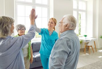 Senior people retirement home activity, high five with skilled nurse, nursing care and service, happy old people enjoy good time, elder patients under supervising and gerontological guiding, playing