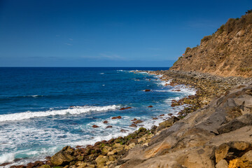 Capturing the essence of Tenerife’s El Socorro beach with rocky cliffs and rolling waves