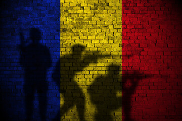 romania flag on brick wall and soldiers shadow