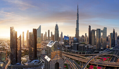 Obraz premium Dubai skyline at sunset with traffic - aerial view, United Arab Emirates