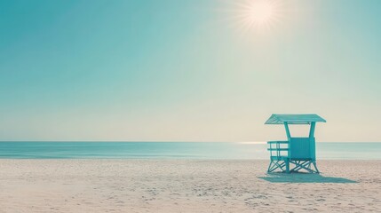 A lone lifeguard stand on a pristine sandy beach with a bright blue sky and a shining sun.