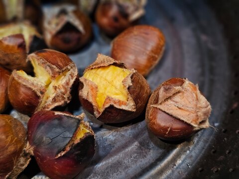 Close up of grilled chesnuts on pan.