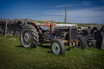 Old grey vintage farmer tractor on the land  in a beautiful environment in Scotland, photo taken...