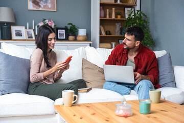 Young couple having communication and trust problem about spending money, arguing about buying new...