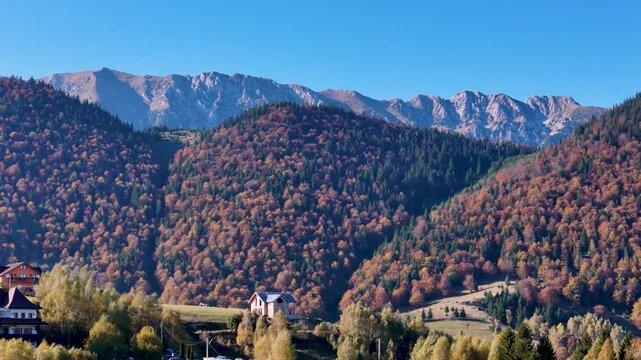 Breathtaking Aerial of Pestera Village Surrounded by Autumn Peaks, Romania, Europe