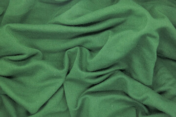 Abstract texture a wrinkled green  blanket