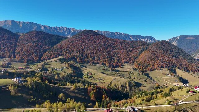 Aerial View of Pestera Village Enveloped by Majestic Autumn Peaks, Romania, Europe