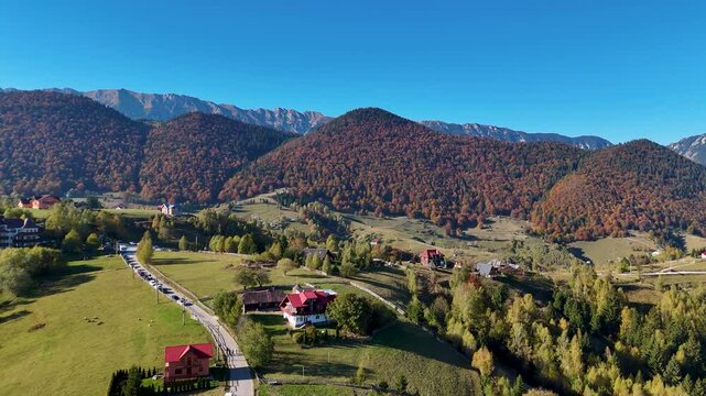 Aerial View of Pestera Mountain Village, Surrounded by Tall Peaks and Autumn Scenery, Romania, Europe