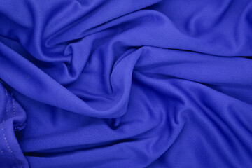 Abstract texture a wrinkled navy blue blanket