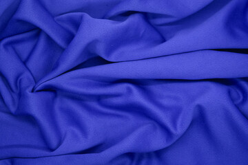 Abstract texture a wrinkled navy blue blanket