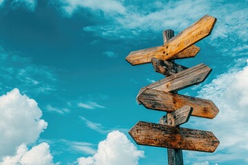 Wooden signpost against blue sky. This image is perfect for representing choice, decision, or direction.