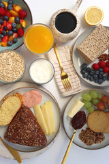Assortment of various breakfast foods and drinks on the white table. Flat lay.