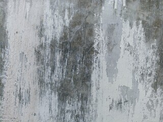Rough Concrete Wall with Peeling Paint and Streaks. Textured concrete wall with aged peeling paint and vertical streaks, ideal for industrial backgrounds