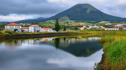 Fototapeta premium Calm River Reflecting Village Beside Volcano Under Cloudy Sky