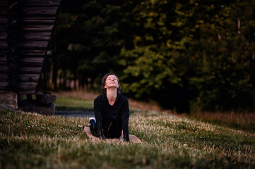 Fototapeta premium Woman practicing yoga outdoors in a serene setting