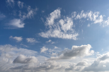 Serene Blue Sky with Fluffy White Clouds Under Natural Light