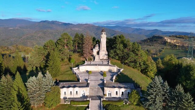 Slow Aerial reveal of Mateias Mausoleum at Sunset Surrounded by Peaks, Arges County, Romania